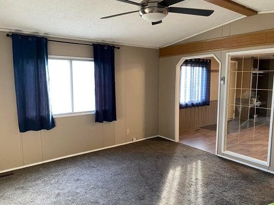 Mobile home living room with carpet.