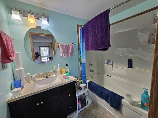 Bathroom with bathtub and vanity.