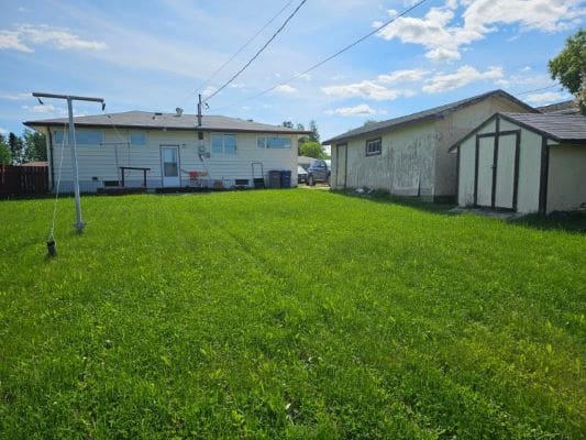 House, garage, and green lawn.