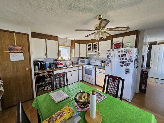 Kitchen with table, chairs, and appliances.