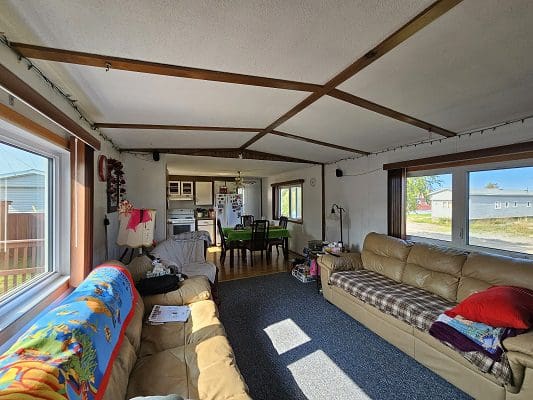Spacious living room with large windows.
