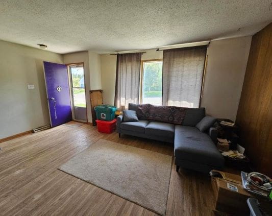 Living room with sectional sofa and purple door.