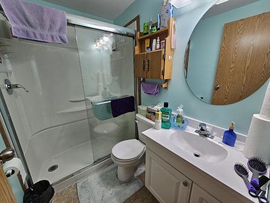 Bathroom with shower, toilet, and sink.