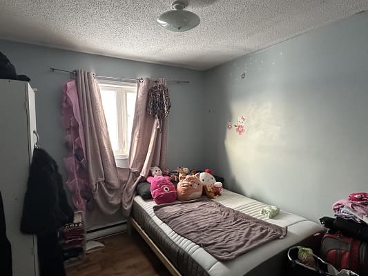 Child's bedroom with bed and toys.