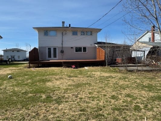Backyard view of a suburban two-story house.