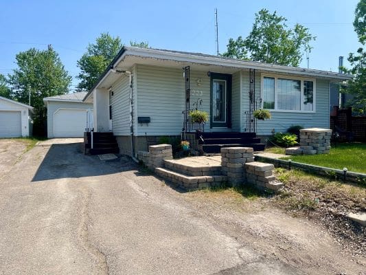 Small suburban house with driveway and garage.