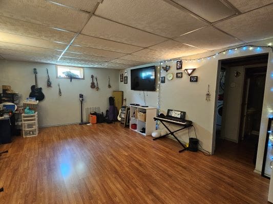 Basement room with guitars and keyboard.