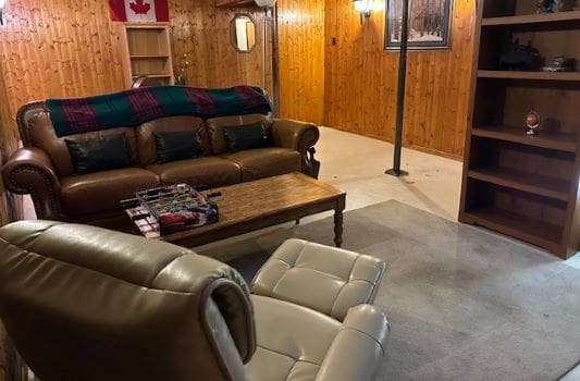 Cozy basement room with leather furniture.