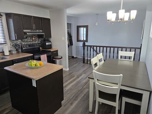 Modern kitchen and dining area with island.