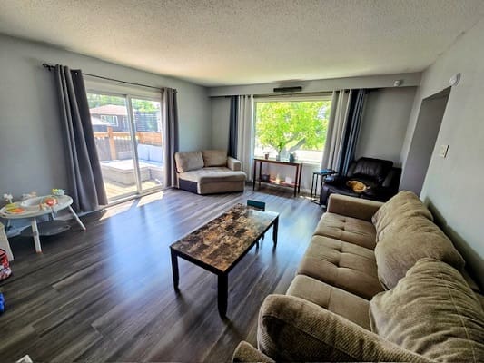 Spacious living room with large windows.