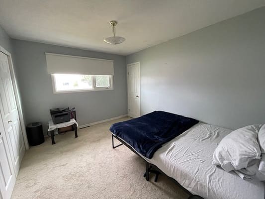 Minimalist bedroom with bed and window.
