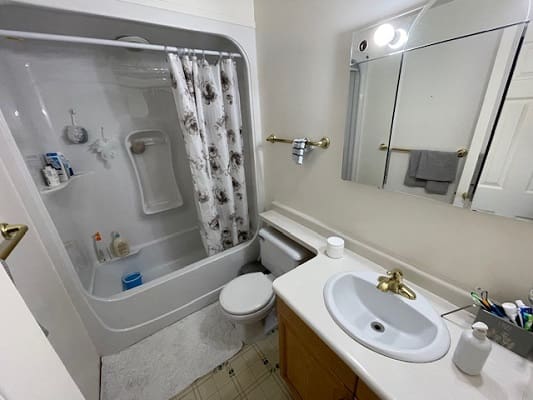 Small bathroom with shower and sink.