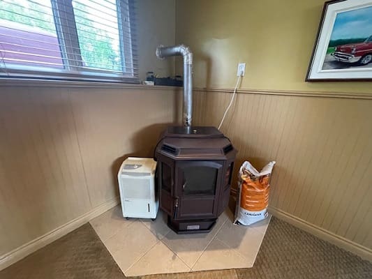Wood stove corner setup with supplies.