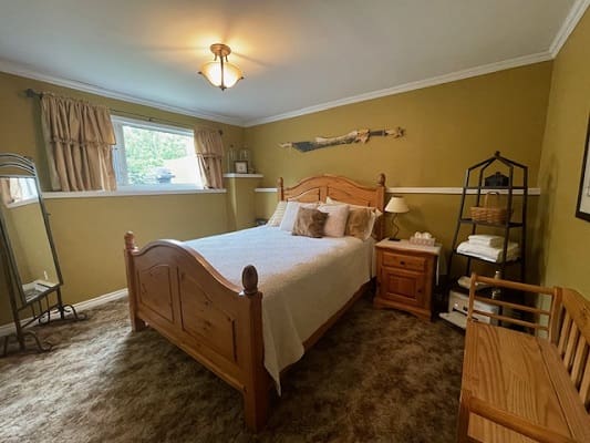 Cozy bedroom with wooden furniture and decor.