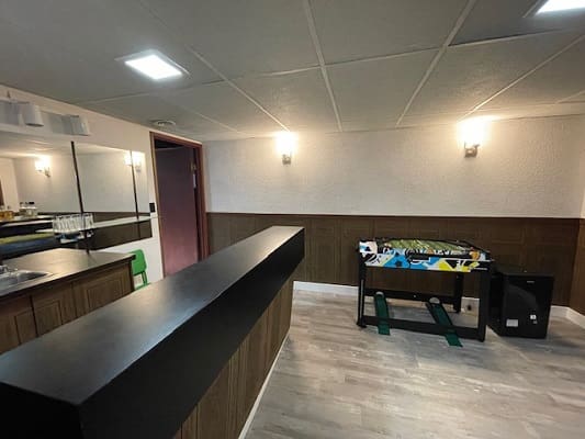 Basement room with foosball table and bar.