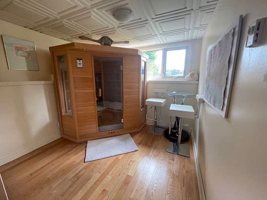 Home sauna room with wooden flooring.