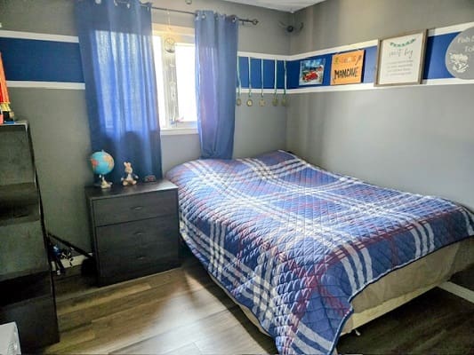 Bedroom with blue plaid bedding and decor.