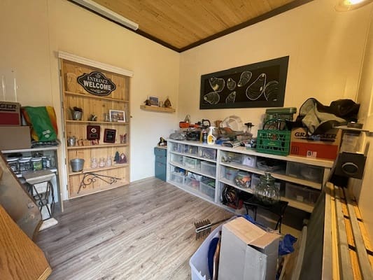 Cozy storage room with wooden shelves.