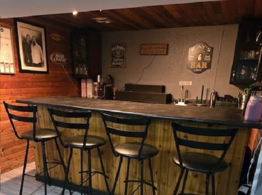 Home bar with stools and wall decor.