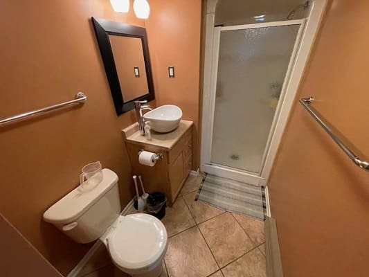 Small bathroom with shower and vanity sink.