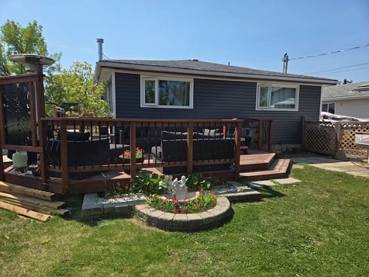 Backyard deck with seating and garden.