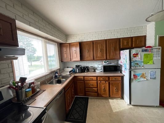 Cozy kitchen with wooden cabinets and appliances.