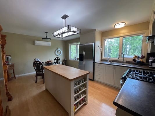 Modern kitchen with island and dining area.