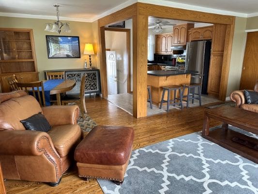 Open-plan living room with kitchen and furniture.