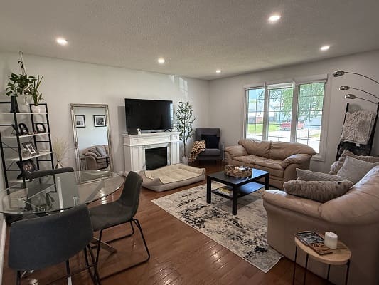 Modern living room with sofas and fireplace.