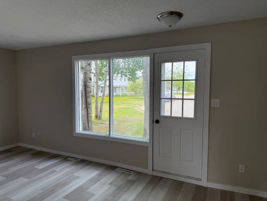 Empty room with window and door.