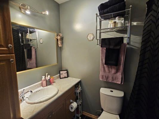 Small bathroom with sink and towel rack.