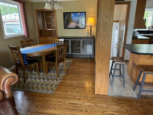 Dining area with wooden table and chairs.