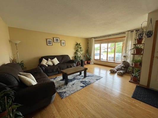 Spacious living room with large window view.