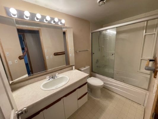 Bathroom with shower, sink, and mirror.