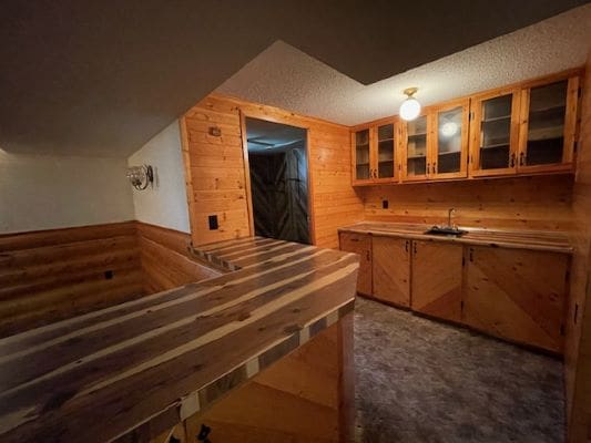 Rustic wooden kitchen with countertop and cabinets.