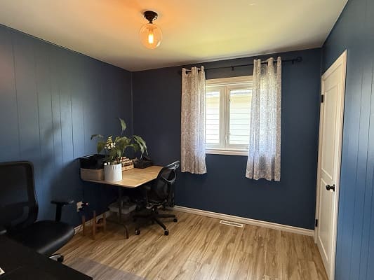 Home office with blue walls and desk.