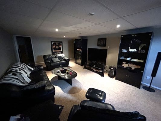 Cozy basement living room with black furniture.
