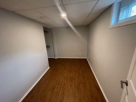 Empty room with wooden floor and window.