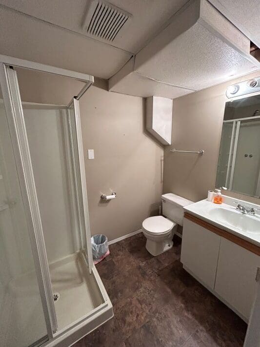 Small bathroom with shower and toilet.