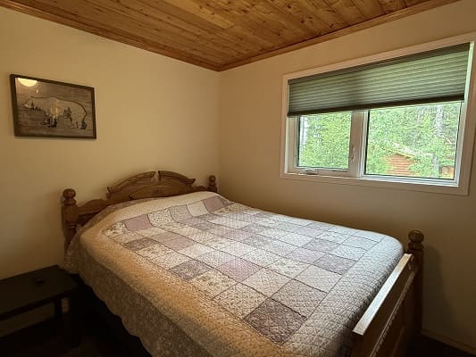 Cozy bedroom with quilted bedspread.