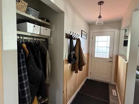 Hallway with coats and a door entrance.