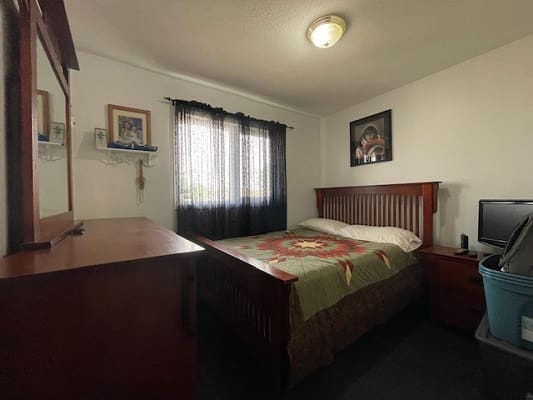 Cozy bedroom with wooden furniture and decor.