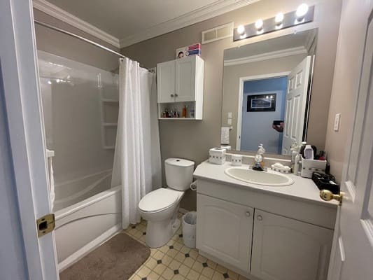 Small bathroom with shower and vanity.