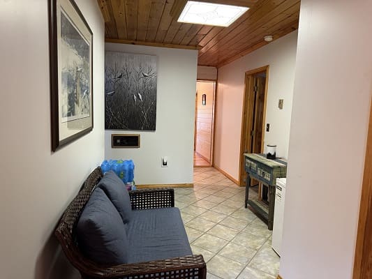 Hallway with sofa and wall art.