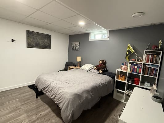 Cozy bedroom with a bed and shelves.