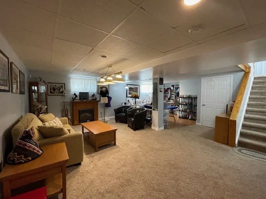 Basement lounge with sofa and armchairs.