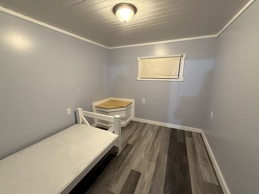 Small, empty room with light gray walls.