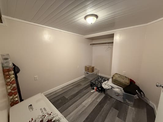 Small room with storage boxes and decorations.