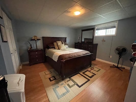 Cozy bedroom with wooden furniture and decor.