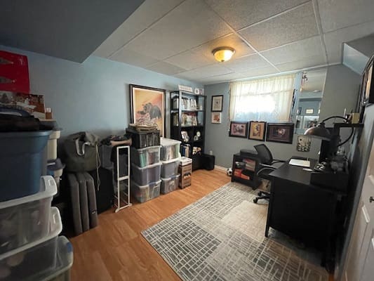 Home office with desk and storage bins.
